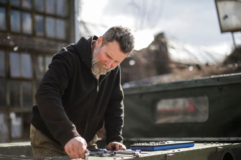 Mechanic working with a socket set outdoors on a service call